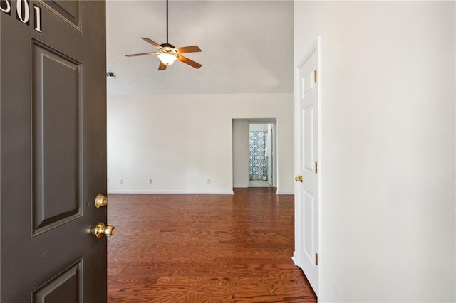 spare room featuring lofted ceiling, dark hardwood / wood-style floors, and ceiling fan