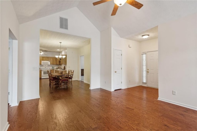 living room featuring high vaulted ceiling, ceiling fan with notable chandelier, and dark hardwood / wood-style flooring