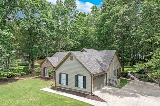 2105 Huntington Hills Trce, Buford, GA 30519 - view of front facade featuring concrete driveway, a garage, and a front lawn