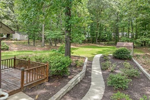 2105 Huntington Hills Trce, Buford, GA 30519 - view of grassy yard with a wooden deck