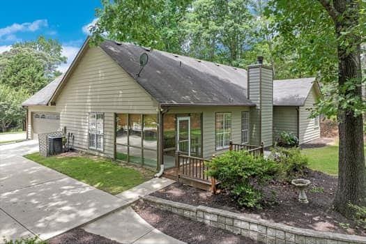 2105 Huntington Hills Trce, Buford, GA 30519 - view of front of house with a garage, a chimney, and driveway
