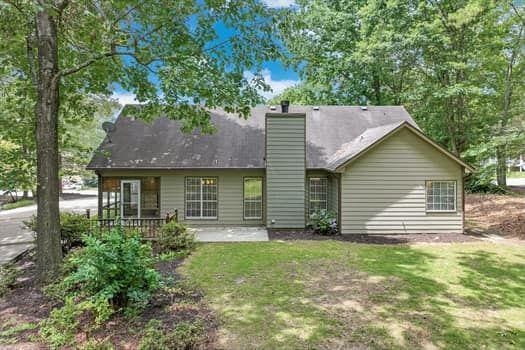 2105 Huntington Hills Trce, Buford, GA 30519 - rear view of property with a chimney, a patio area, and a yard