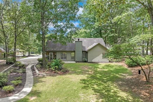 2105 Huntington Hills Trce, Buford, GA 30519 - rear view of property featuring a yard