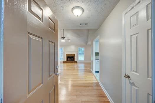 2105 Huntington Hills Trce, Buford, GA 30519 - hallway with light wood-style floors and a textured ceiling