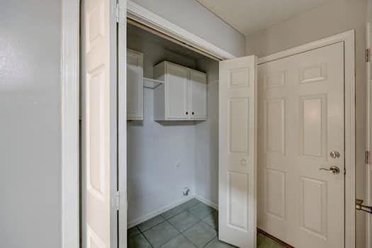 2105 Huntington Hills Trce, Buford, GA 30519 - washroom with light tile patterned floors and baseboards