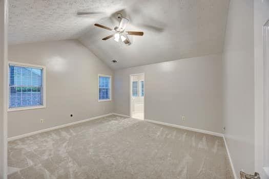 2105 Huntington Hills Trce, Buford, GA 30519 - unfurnished room featuring carpet floors, ceiling fan, and vaulted ceiling