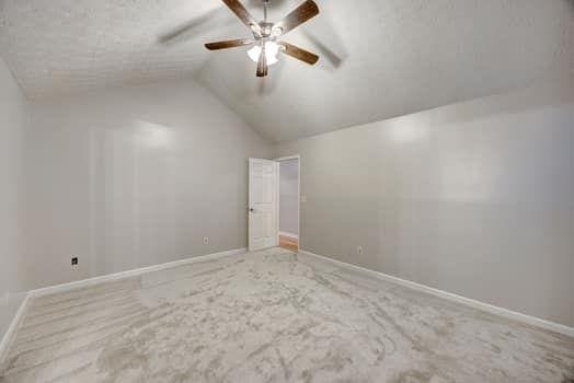 2105 Huntington Hills Trce, Buford, GA 30519 - additional living space with a ceiling fan, lofted ceiling, and carpet floors