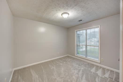 2105 Huntington Hills Trce, Buford, GA 30519 - unfurnished room featuring carpet and a textured ceiling