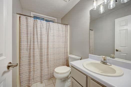 2105 Huntington Hills Trce, Buford, GA 30519 - full bathroom with vanity, tile patterned flooring, and curtained shower