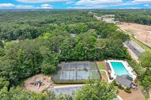 2105 Huntington Hills Trce, Buford, GA 30519 - aerial view of property's location featuring a forest and a pool area