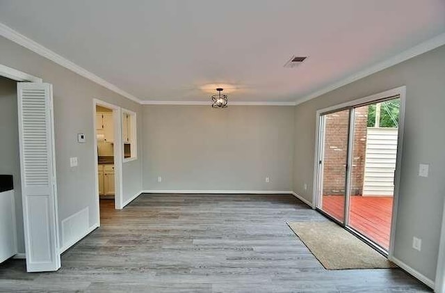 6500 Gaines Ferry Rd Unit A2, Flowery Branch, GA 30542 - spare room featuring crown molding, wood finished floors, and baseboards