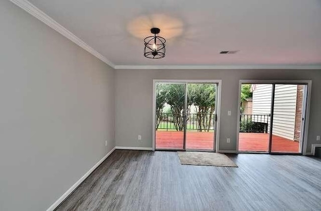 6500 Gaines Ferry Rd Unit A2, Flowery Branch, GA 30542 - spare room featuring wood finished floors, baseboards, and crown molding