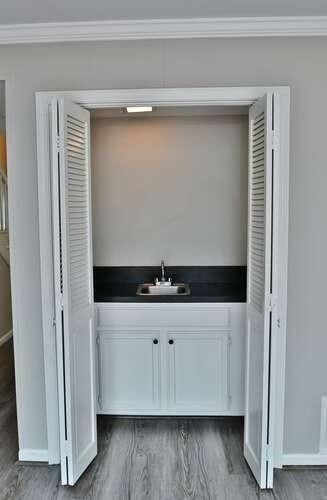 6500 Gaines Ferry Rd Unit A2, Flowery Branch, GA 30542 - detailed view of a sink, ornamental molding, wood finished floors, and baseboards