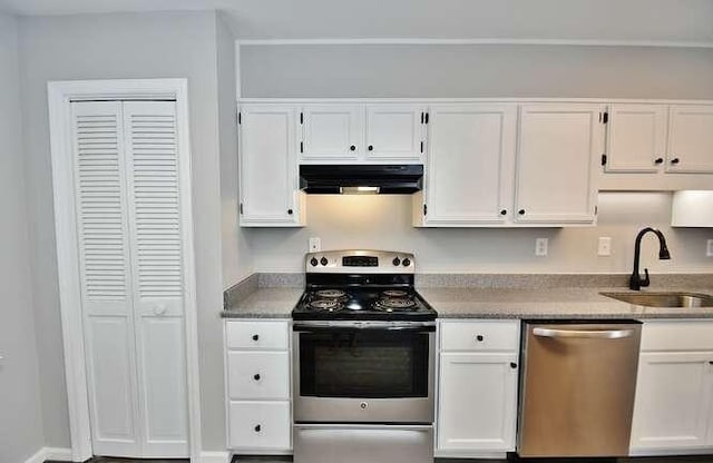 6500 Gaines Ferry Rd Unit A2, Flowery Branch, GA 30542 - kitchen featuring stainless steel appliances, ventilation hood, a sink, and white cabinetry