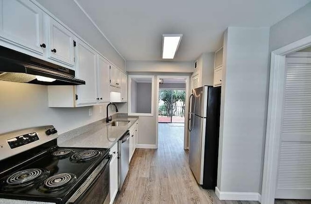 6500 Gaines Ferry Rd Unit A2, Flowery Branch, GA 30542 - kitchen featuring appliances with stainless steel finishes, a sink, under cabinet range hood, white cabinetry, and light wood-style flooring