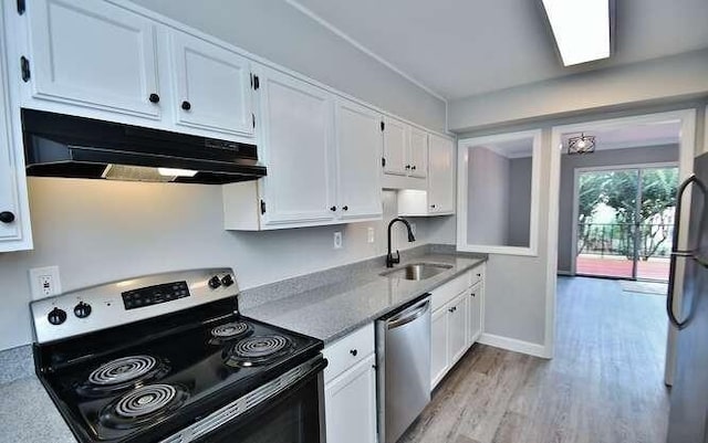 6500 Gaines Ferry Rd Unit A2, Flowery Branch, GA 30542 - kitchen with stainless steel appliances, under cabinet range hood, a sink, white cabinets, and light wood-style flooring