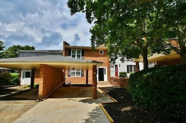 6500 Gaines Ferry Rd Unit A2, Flowery Branch, GA 30542 - view of front facade with driveway, a carport, and brick siding
