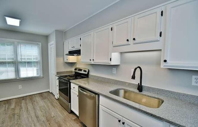 6500 Gaines Ferry Rd Unit A2, Flowery Branch, GA 30542 - kitchen with stainless steel appliances, a sink, white cabinetry, light wood-type flooring, and exhaust hood