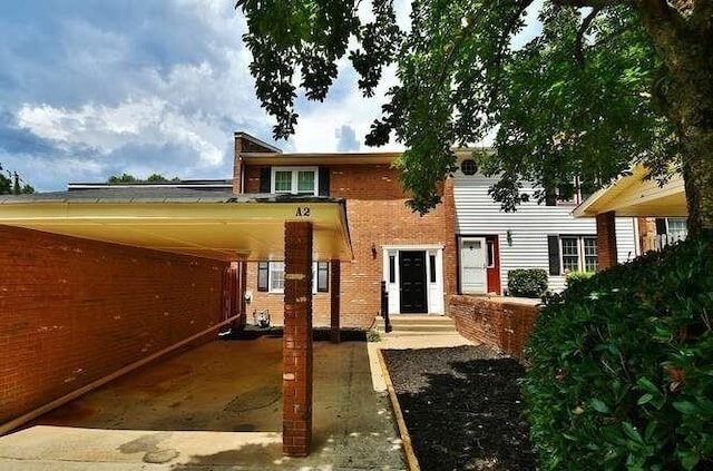 6500 Gaines Ferry Rd Unit A2, Flowery Branch, GA 30542 - view of front facade featuring brick siding and an attached carport