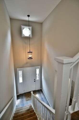 6500 Gaines Ferry Rd Unit A2, Flowery Branch, GA 30542 - entrance foyer featuring wood finished floors, healthy amount of natural light, and a high ceiling