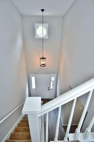6500 Gaines Ferry Rd Unit A2, Flowery Branch, GA 30542 - stairs with a towering ceiling and baseboards