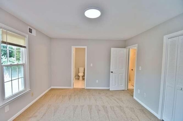 6500 Gaines Ferry Rd Unit A2, Flowery Branch, GA 30542 - unfurnished bedroom with light colored carpet, baseboards, a closet, and ensuite bath