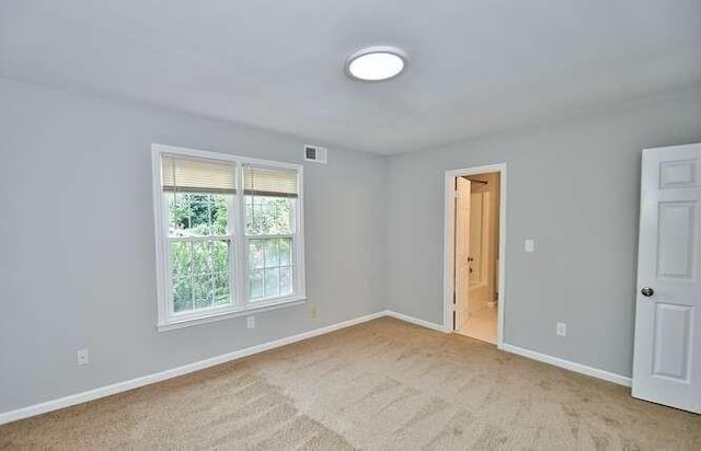 6500 Gaines Ferry Rd Unit A2, Flowery Branch, GA 30542 - unfurnished bedroom with baseboards, light colored carpet, and connected bathroom