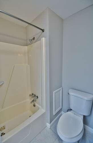 6500 Gaines Ferry Rd Unit A2, Flowery Branch, GA 30542 - bathroom featuring baseboards, bathtub / shower combination, toilet, and tile patterned flooring