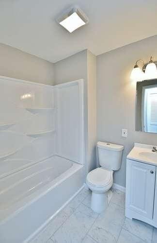 6500 Gaines Ferry Rd Unit A2, Flowery Branch, GA 30542 - bathroom with vanity, toilet,  shower combination, and baseboards