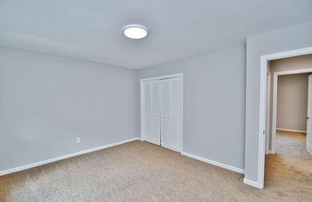 6500 Gaines Ferry Rd Unit A2, Flowery Branch, GA 30542 - unfurnished bedroom with a closet, carpet, and baseboards