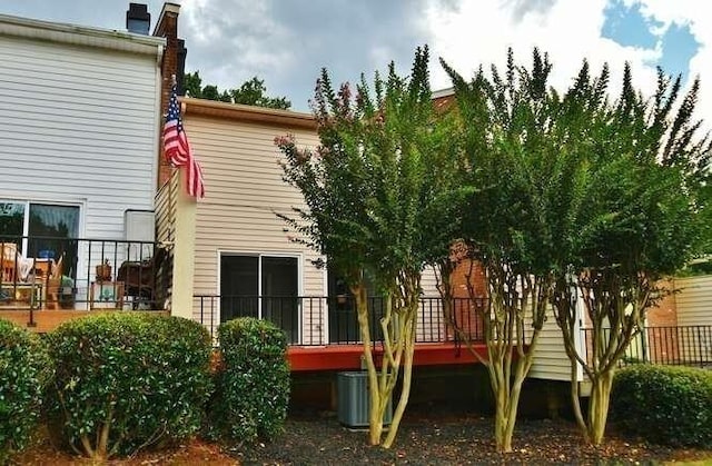 6500 Gaines Ferry Rd Unit A2, Flowery Branch, GA 30542 - back of house with a chimney, central AC, and a wooden deck