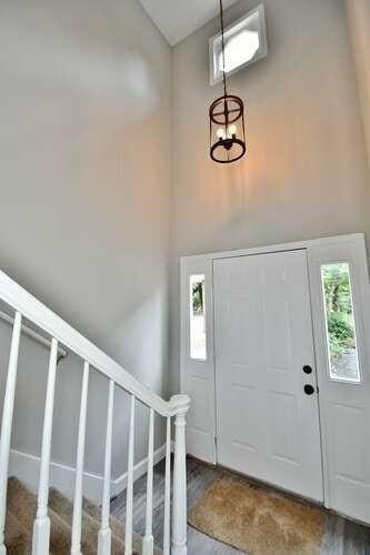 6500 Gaines Ferry Rd Unit A2, Flowery Branch, GA 30542 - entryway with high vaulted ceiling, stairs, and wood finished floors