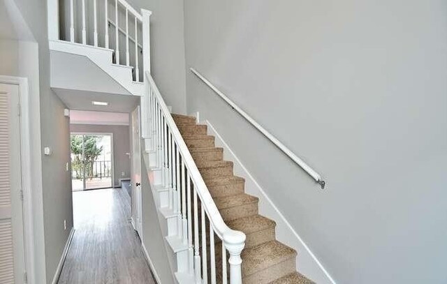 6500 Gaines Ferry Rd Unit A2, Flowery Branch, GA 30542 - stairs with wood finished floors, baseboards, and a high ceiling