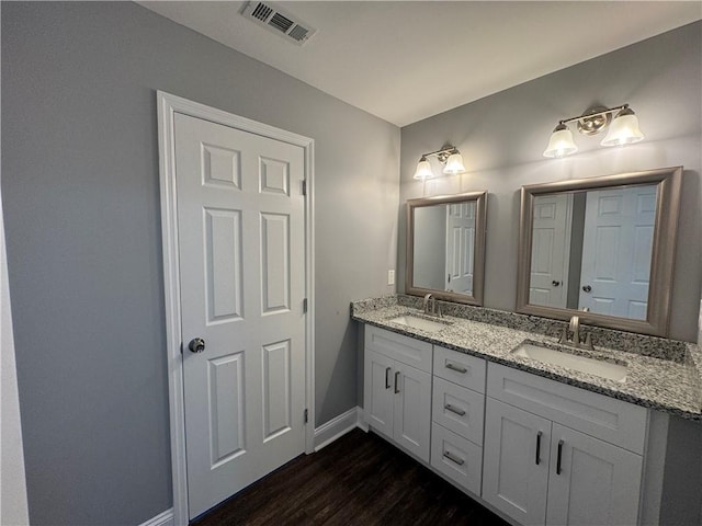 bathroom with vanity and hardwood / wood-style floors