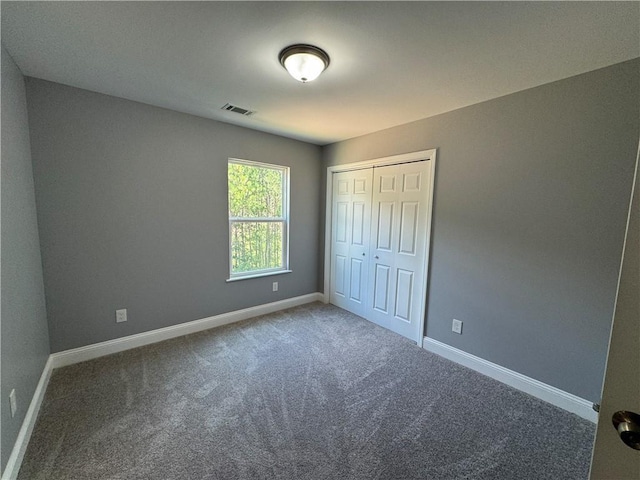 unfurnished bedroom with a closet and carpet flooring