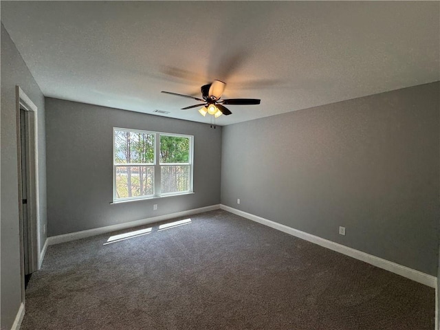 carpeted spare room featuring ceiling fan and a textured ceiling