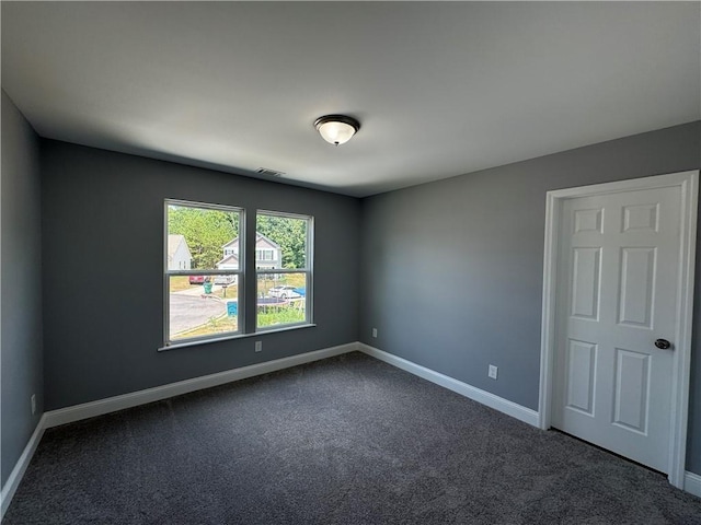 empty room with dark carpet