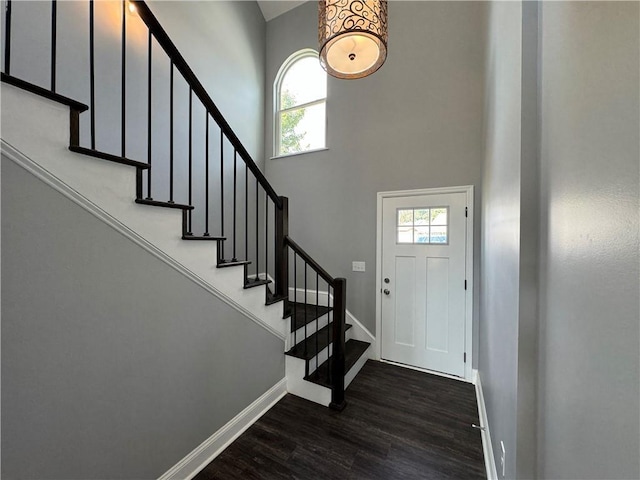 entryway with plenty of natural light and dark wood-type flooring