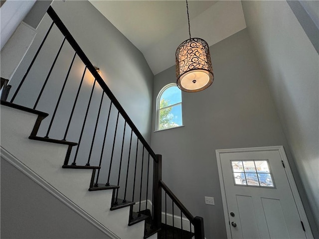 entryway featuring plenty of natural light and high vaulted ceiling