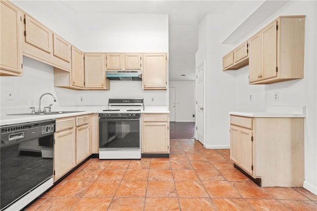 kitchen featuring light brown cabinetry, under cabinet range hood, dishwasher, light countertops, and range with gas stovetop