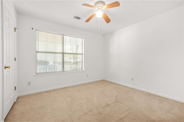 unfurnished room featuring light carpet, visible vents, and baseboards