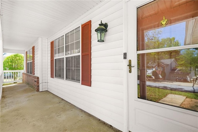 view of exterior entry featuring a porch