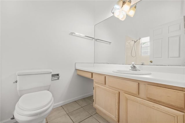 bathroom with vanity, baseboards, a chandelier, tile patterned flooring, and toilet