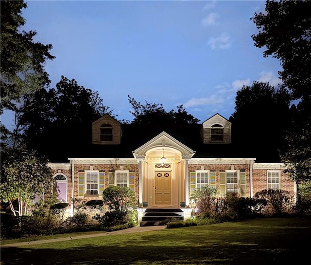 1821 N Rock Springs Rd NE, Atlanta, GA 30324 - new england style home featuring brick siding and a front yard