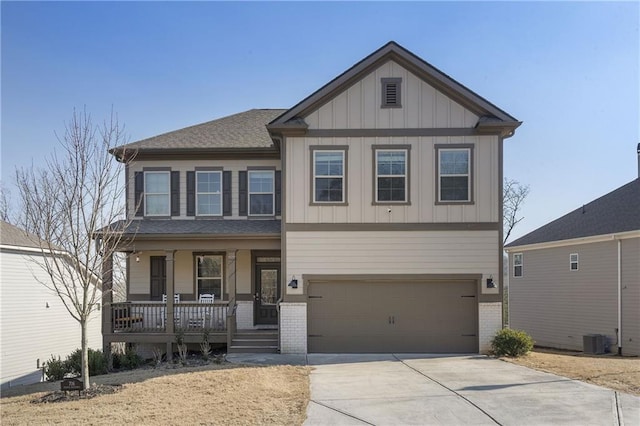 craftsman-style home with a porch, central AC, board and batten siding, concrete driveway, and a garage