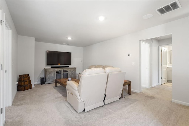 living room featuring recessed lighting, visible vents, light carpet, and attic access