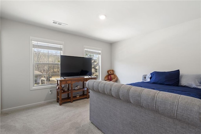 bedroom with visible vents, light colored carpet, and baseboards