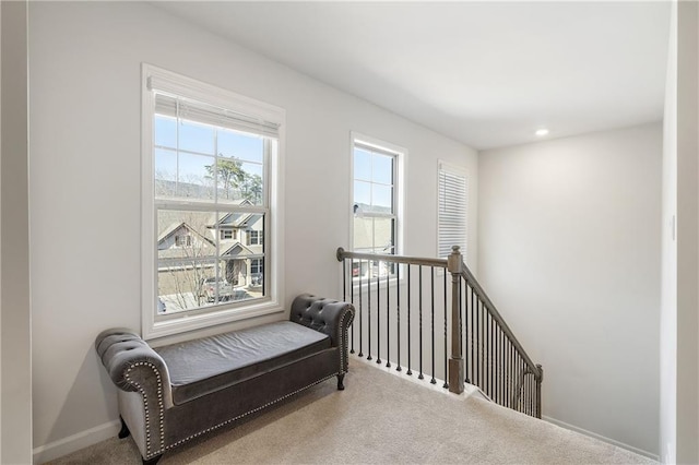 sitting room featuring recessed lighting, an upstairs landing, baseboards, and carpet floors