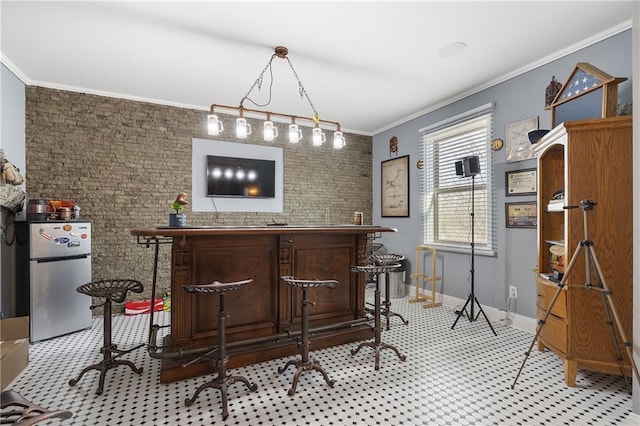 bar with baseboards, ornamental molding, a dry bar, and freestanding refrigerator