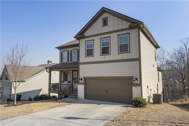 craftsman inspired home with concrete driveway, an attached garage, central AC unit, and brick siding